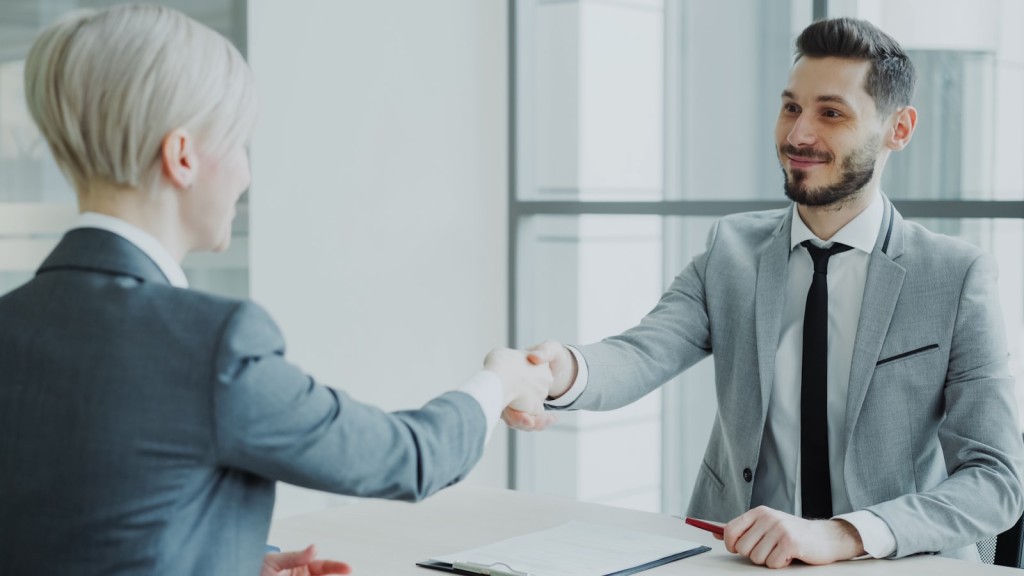HR manager shaking hands with a job candidate after a successful Python developer interview