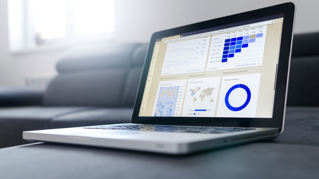 Laptop on a casual workspace showing statistics and charts on screen during a self-paced data analysis session